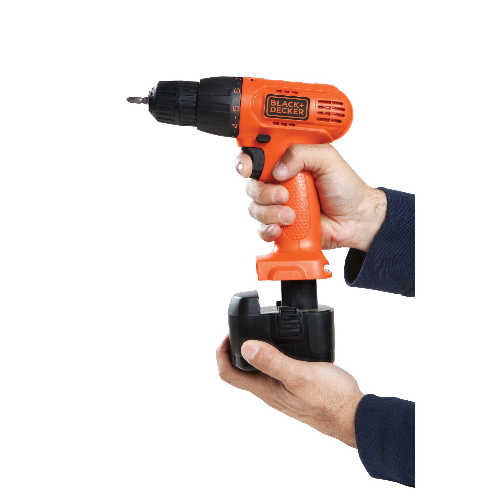 BLACKDECKER CD121K50 cordless drill held by hand, battery being inserted, product side angle, orange and black.