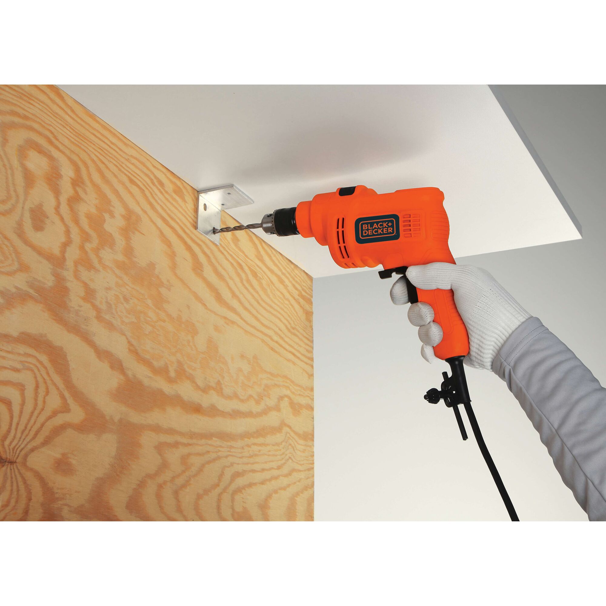 BLACKDECKER KR5010V orange corded drill used for drilling metal bracket onto wood panel.