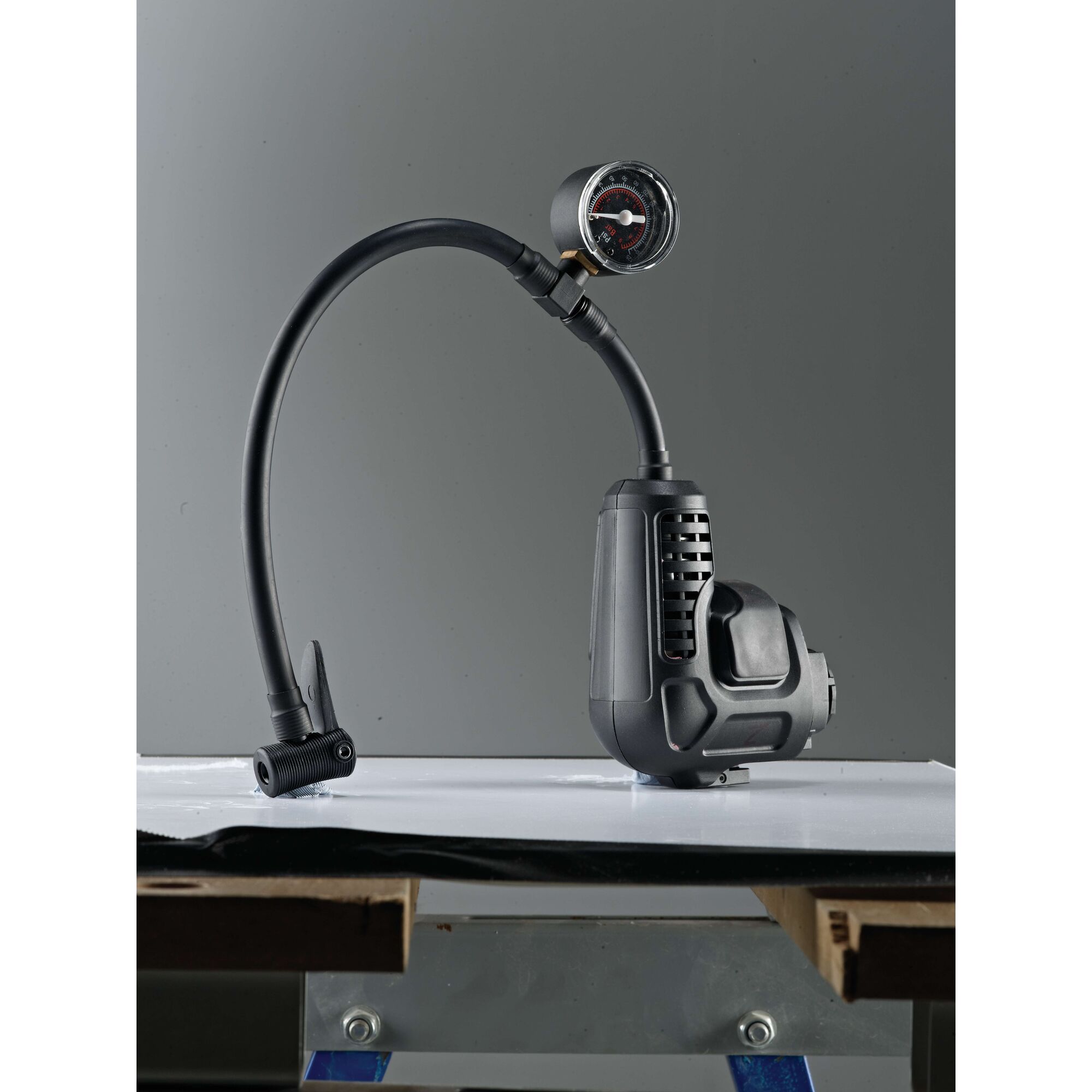 BLACKDECKER MTNF9 tire inflator MT218K_E1 with gauge, black, side angle, on white surface.